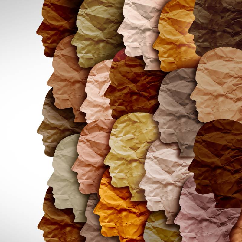 Abstract collage art of different coloured faces made out of crinkled paper